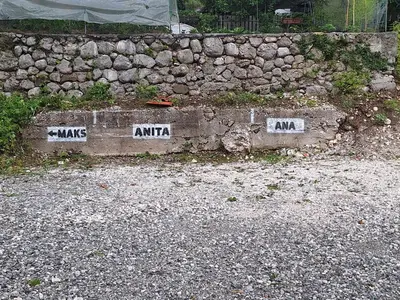 a stone wall with signs that say mars and antaria at Apartma Maks & Anita in Bovec