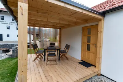 a wooden deck with a table and chairs on it at Ribiška vasica - Fishermen's Village in Radeče