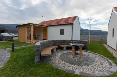 a backyard with a picnic table and a building at Ribiška vasica - Fishermen's Village in Radeče