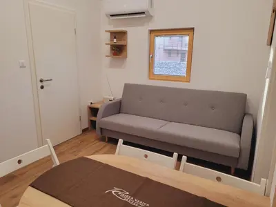 a living room with a couch and a table at Ribiška vasica - Fishermen's Village in Radeče