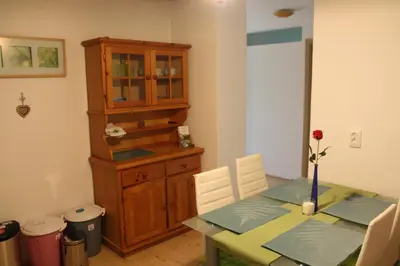 a dining room with a table and a cabinet at Dream Apartment Brglez in Bohinjska Bela