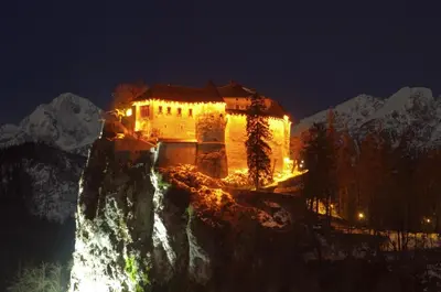 a building on the side of a mountain at night at Dream Apartment Brglez in Bohinjska Bela