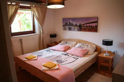 a bedroom with a bed with two towels on it at Dream Apartment Brglez in Bohinjska Bela