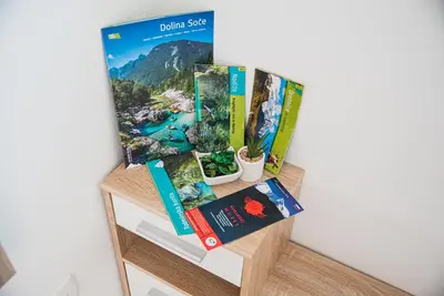 a shelf with books and magazines on a wall at CUDERLAND STUDIO KURNIK in Kobarid