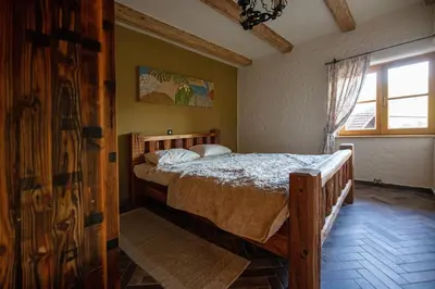 a bedroom with a bed in a room with a window at Rose garden in Ljubno