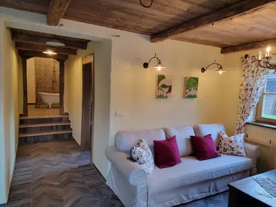a living room with a couch with pillows on it at Rose garden in Ljubno