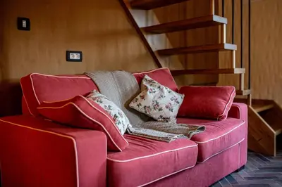 a pink couch with pillows on it in a room at Rose garden in Ljubno
