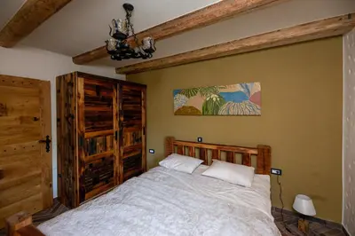 a bedroom with a bed in a room at Rose garden in Ljubno