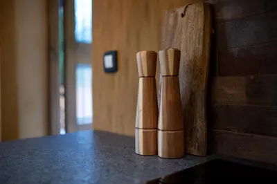 a group of three wooden bats sitting on top of a counter at Rose garden in Ljubno