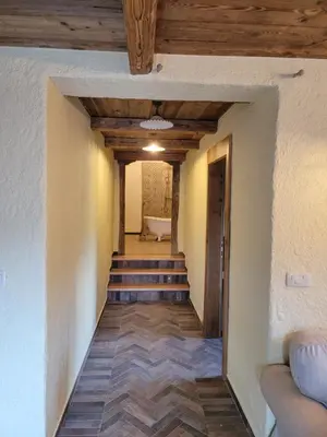 a hallway with stairs leading to a bathroom with a tub at Rose garden in Ljubno