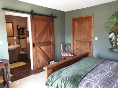 a bedroom with a bed and a wooden door at B&B Margarita in Cerkovna