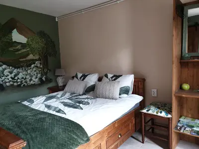 a bedroom with a large bed with white sheets at B&B Margarita in Cerkovna
