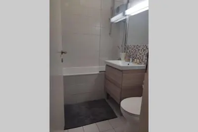 a bathroom with a toilet and a tub and a sink at Studio apartment 