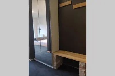 a mirror in the corner of a room with a table at Studio apartment 