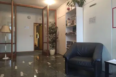 a living room with a leather couch and a plant at Studio apartment 