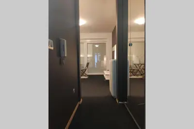 a hallway of an office with a desk and a room at Studio apartment 