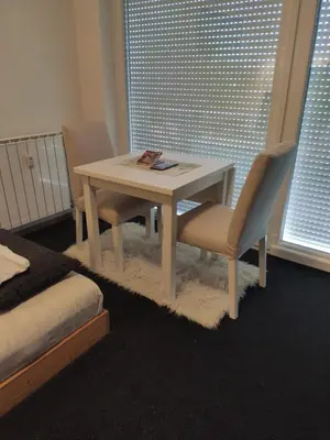 a table and two chairs in a room with a window at Studio apartment 
