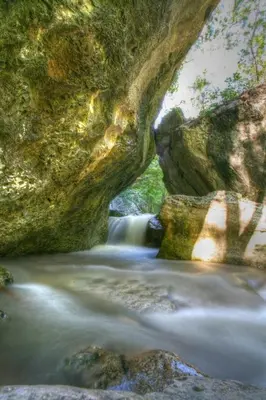a picture of a river flowing through a rock formation at APARTMA KMETIJA ROVAN in Vrhpolje
