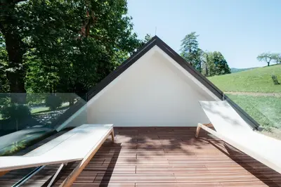 a roof extension of a house with a glass wall at Spa Suite Dobrna - Terme Dobrna in Dobrna
