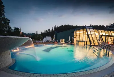 a large pool with a water fountain in front of a building at Spa Suite Dobrna - Terme Dobrna in Dobrna