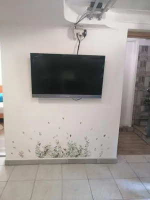 a flat screen tv hanging on a white wall at Freya in Lesce