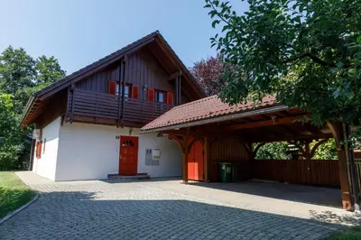 a building with a red door and a wooden roof at Villa Toni in Bled