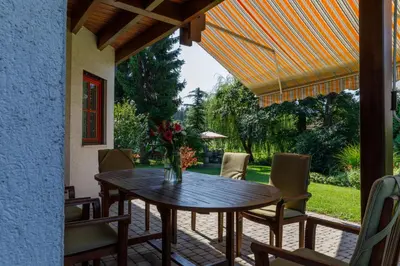 a table with a vase of flowers on a patio at Villa Toni in Bled