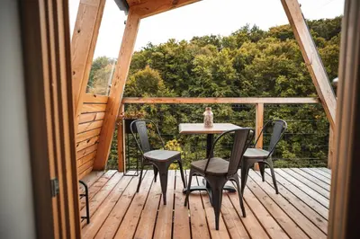 a wooden deck with a table and chairs on it at Nesting Resort - Homestead SONČNI RAJ in Maribor
