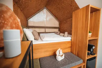 a small room with a bed in a small house at Nesting Resort - Homestead SONČNI RAJ in Maribor