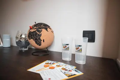 a wooden table with two glasses and a globe on it at Nesting Resort - Homestead SONČNI RAJ in Maribor