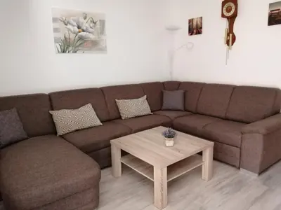 a living room with a brown couch and a coffee table at Apartma TIA in Bled
