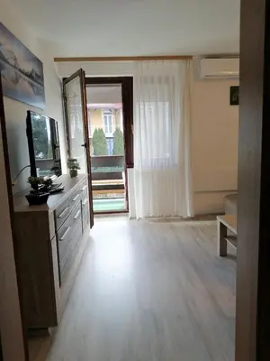 a room with a mirror and a dresser and a window at Apartma TIA in Bled