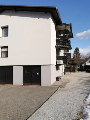 a white building with a staircase on the side of it at Apartma TIA in Bled