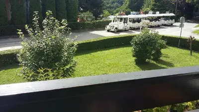 a fire truck is parked in a yard with bushes at Apartma TIA in Bled