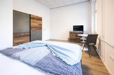 a bedroom with a bed and a desk at Epicenter - rooms & terrace in Ljubljana