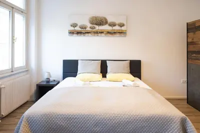a bedroom with a large bed in a room at Epicenter - rooms & terrace in Ljubljana