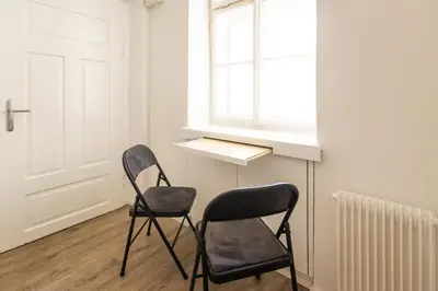 two chairs sitting in a room with a window at Epicenter - rooms & terrace in Ljubljana