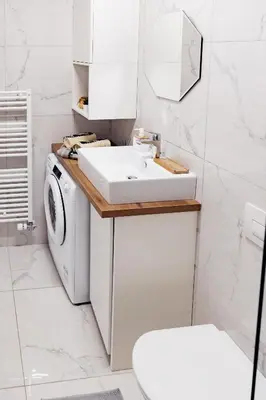 a bathroom with a sink and a washing machine at Woody - comfy apartment in Šiška in Ljubljana