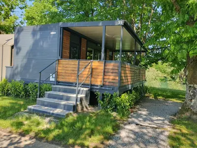 a tiny house with glass walls and stairs at GM House, mobile house near Kolpa river in Metlika