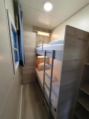 a small room with two bunk beds in it at GM House, mobile house near Kolpa river in Metlika