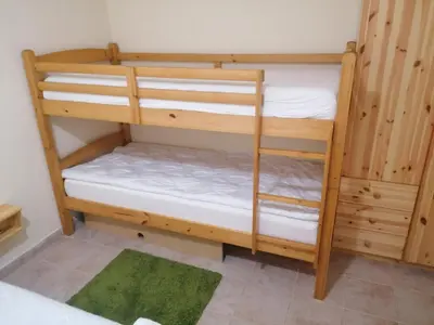 a couple of bunk beds in a room at Rogla - Apartma ROŽLE in Vitanje