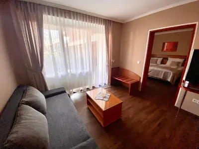 a living room with a couch and a mirror at Udoben apartma v Moravskih Toplicah in Moravske Toplice