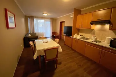 a kitchen with a small table and a kitchen with a couch at Udoben apartma v Moravskih Toplicah in Moravske Toplice