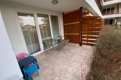 a balcony with a table and chairs on a patio at Udoben apartma v Moravskih Toplicah in Moravske Toplice