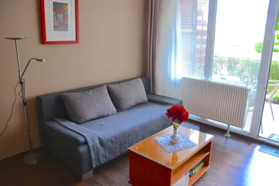a living room with a couch and a table at Udoben apartma v Moravskih Toplicah in Moravske Toplice