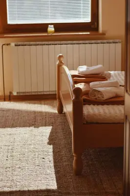 a bedroom with a bed and a window with a radiator at Rooms and Apartments Panker in Moravske Toplice