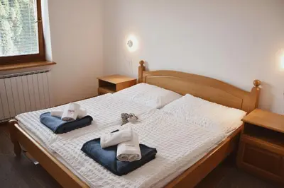 a bedroom with a bed with towels on it at Rooms and Apartments Panker in Moravske Toplice