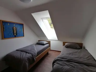 a bedroom with two beds and a window at BLATNIKOV HRAM in Dvor