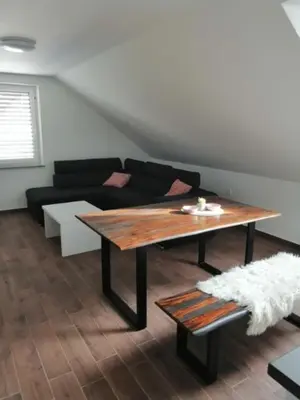 a living room with a table and a couch at BLATNIKOV HRAM in Dvor