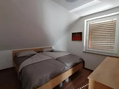 a bedroom with a bed and a window at BLATNIKOV HRAM in Dvor